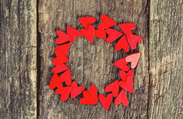 red hearts on rustic wooden surface