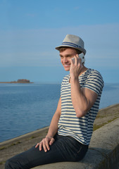 Young man speaking on a cell phone and smiling