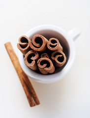 cinnamon in coffee cup on white background