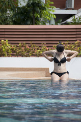 Beautiful Asian woman in swimming pool.