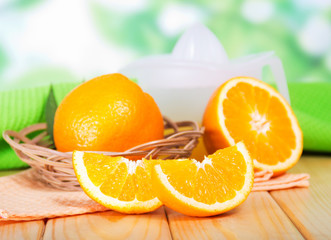 Segments of orange and a juice extractor