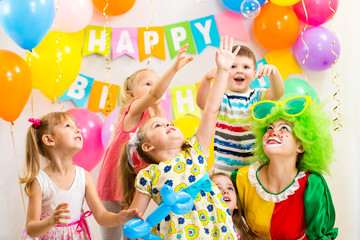 jolly kids group with clown celebrating  birthday party
