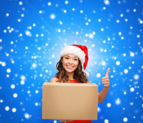 smiling woman in santa helper hat with parcel box