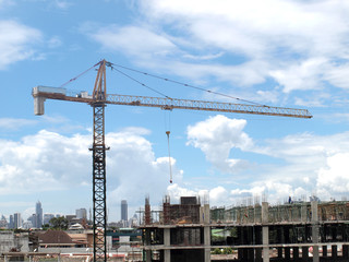 Industrial landscape with cranes on the blue sky