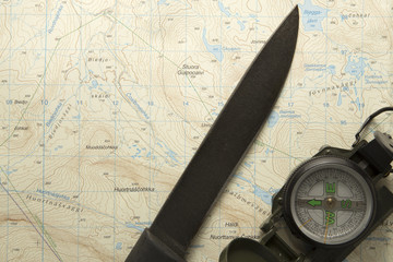 knife and compass on topographic map