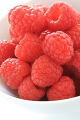 fresh rasberries in white bowl