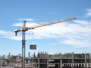 Industrial landscape with cranes on the blue sky