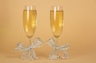 Two glasses with the champagne, decorated silver ribbons
