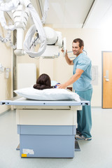 Nurse Adjusting Xray Machine For Patient