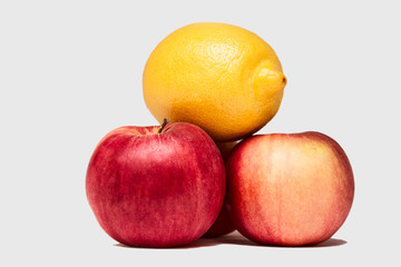 red and yellow apples and lemon