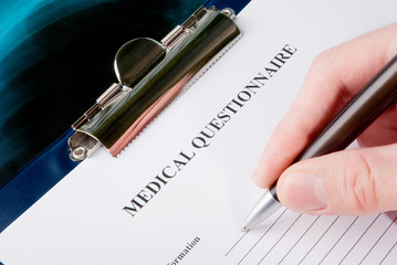 Doctor filling in medical questionnaire on Xray photo of lungs