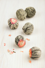 Balls of Chinese green tea on the wooden table.