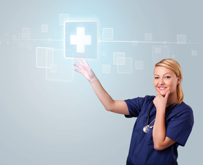 Young nurse pressing modern medical type of buttons