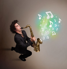 Young musician playing on saxophone while musical notes explodin