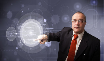 Businessman touching abstract high technology circular buttons