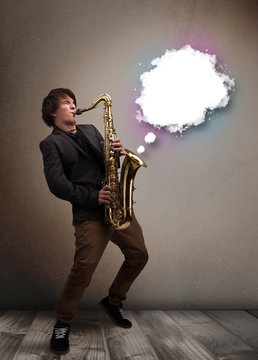 Young man playing on saxophone with copy space in white cloud