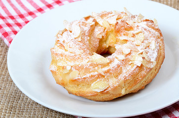 Eclair with a cream on a plate