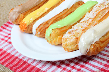 Eclair with a cream on a plate