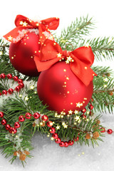 Christmas balls on fir tree with snow, isolated on white