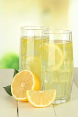 Delicious lemonade on table on light background