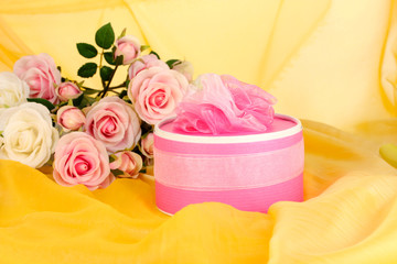 Beautiful gift on flowers background