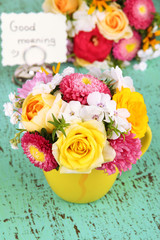 Beautiful bouquet of bright flowers in color vase,
