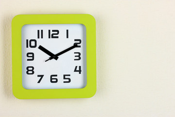 Office clock on color wall background