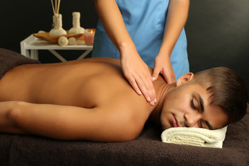 Fototapeta na wymiar Young man having back massage close up