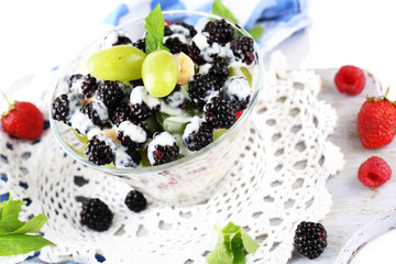 Fruit salad in glass bowl, isolated on white