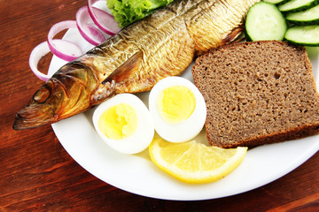 Smoked fish on plate close up