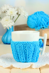 Cup with knitted thing on it close up
