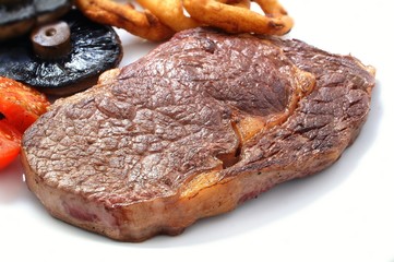 rib eye steak on white plate with vegetables