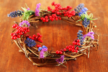 Wreath of dry branches with flowers and viburnum