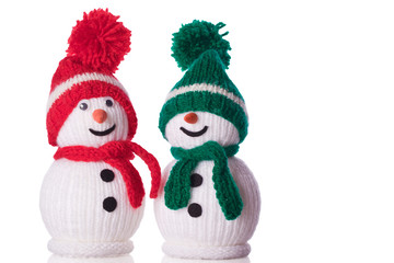 couple of snowman with red and green hat and scarf