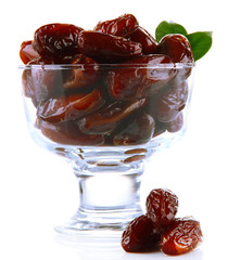 Dried dates in glass bowl isolated on white
