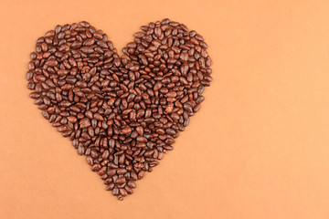 Heart of sunflower grains in chocolate, on brown background