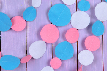 Decorative felt garland on wooden background