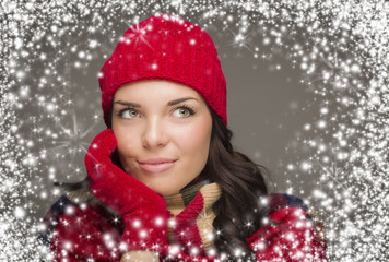 Mixed Race Woman Wearing Winter Hat and Gloves Enjoys Snowfall.