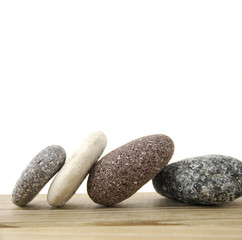 Naklejka na ściany i meble Four stones on a wood board
