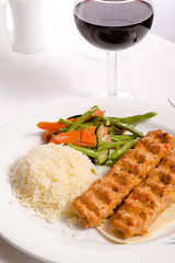 Chicken Adana Kebap Served with Rice Pilaf Vegetables and Red Vi