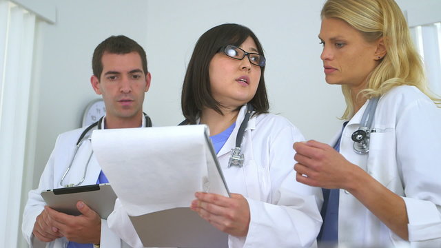 Team of highly skilled doctors reviewing patient's health proble