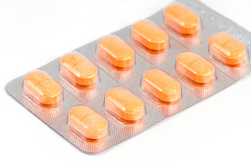 Colorful pills closeup on white background