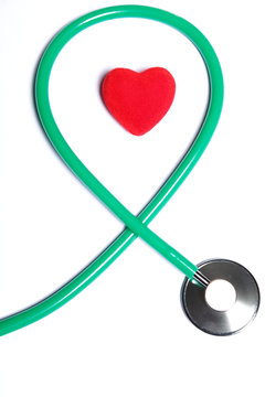 Red heart and green stethoscope isolated