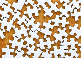 Puzzle pieces with wooden background