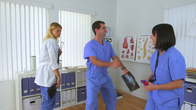 Silly doctors dancing in the office