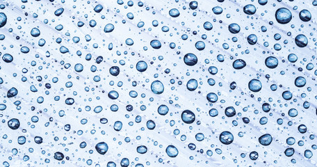 Fototapeta na wymiar Water drops on a plastic background.