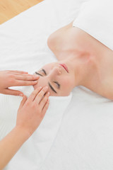 Obraz na płótnie Canvas Hands massaging woman's forehead at beauty spa