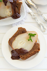 Chocolate cake with pears and chocolate sauce.