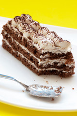 Chocolate cake on a yellow background