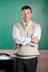 Professor Standing Arms Crossed In Classroom